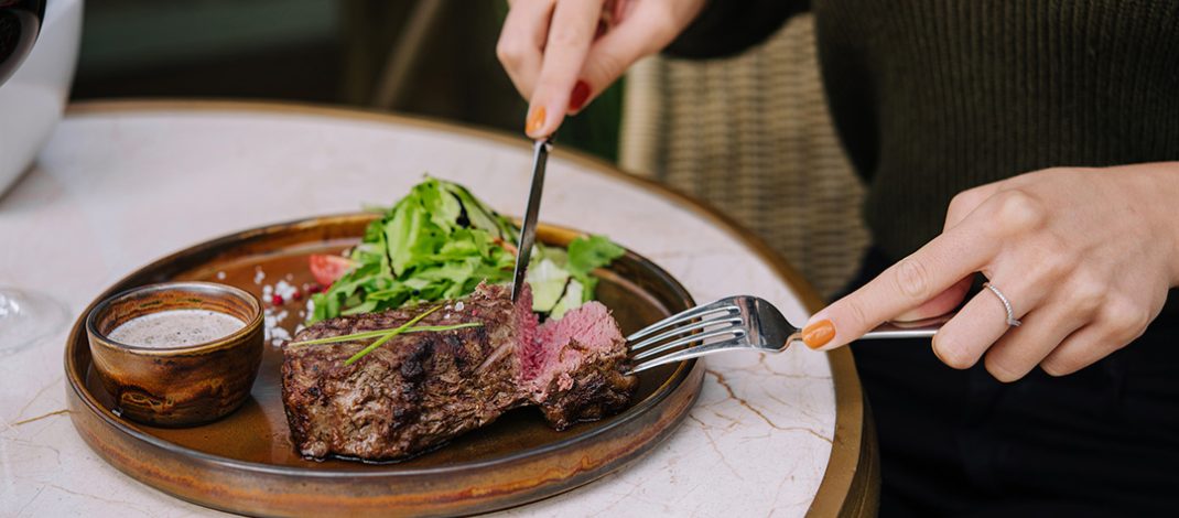 Female eating steak