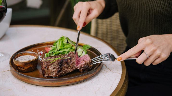 Female eating steak