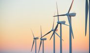 Wind turbine generators for sustainable electrical energy production at sunrise Stock Image